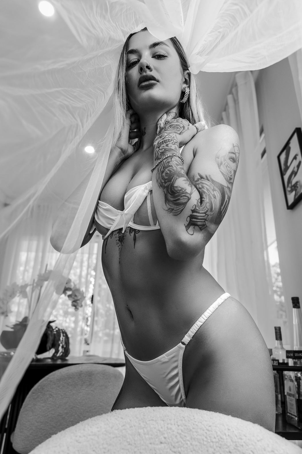 Black and white low-angle bridal portrait beneath a canopy